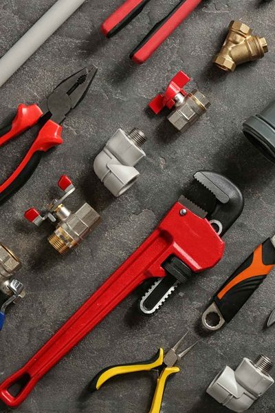 Flat lay composition with plumber’s tools on grey background maintenance-tools-bryanston